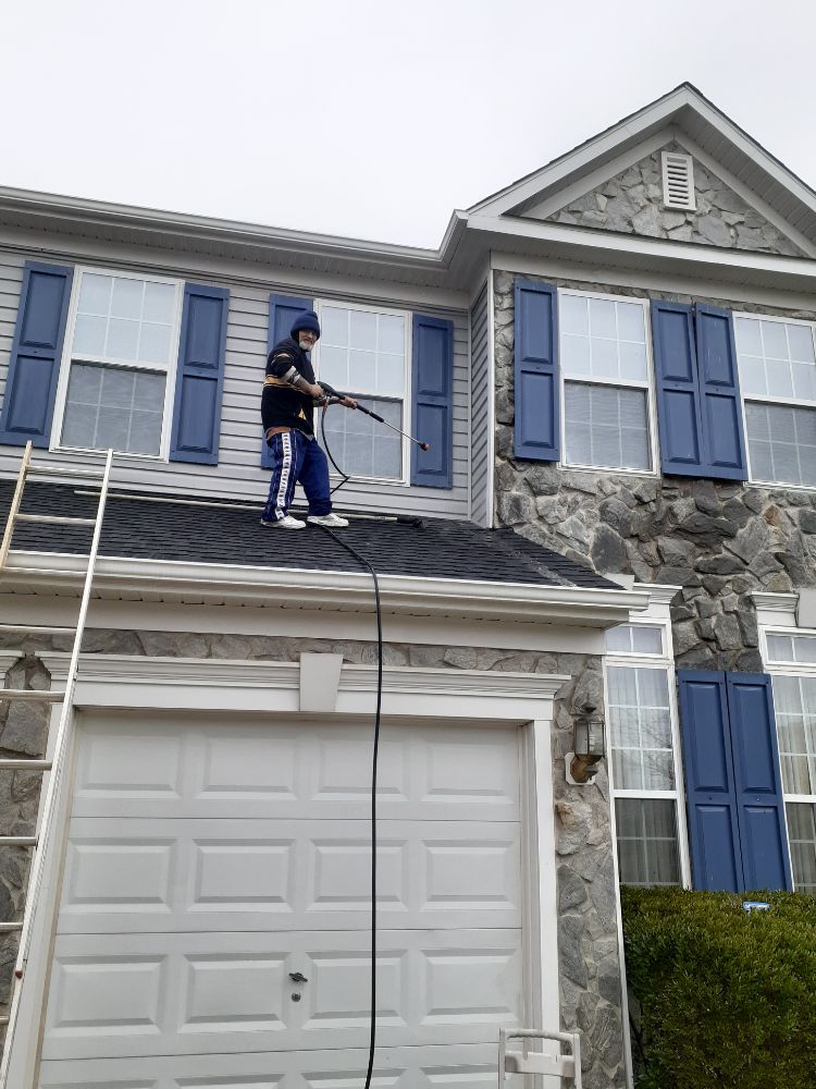 Pressure washing siding and roof on a Baltimore County home