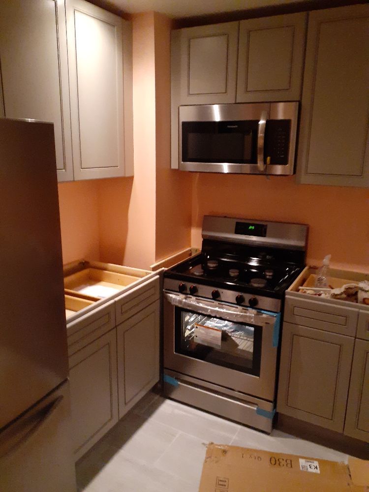 New kitchen cabinets, range and microwave installed by Lastphaze LLC